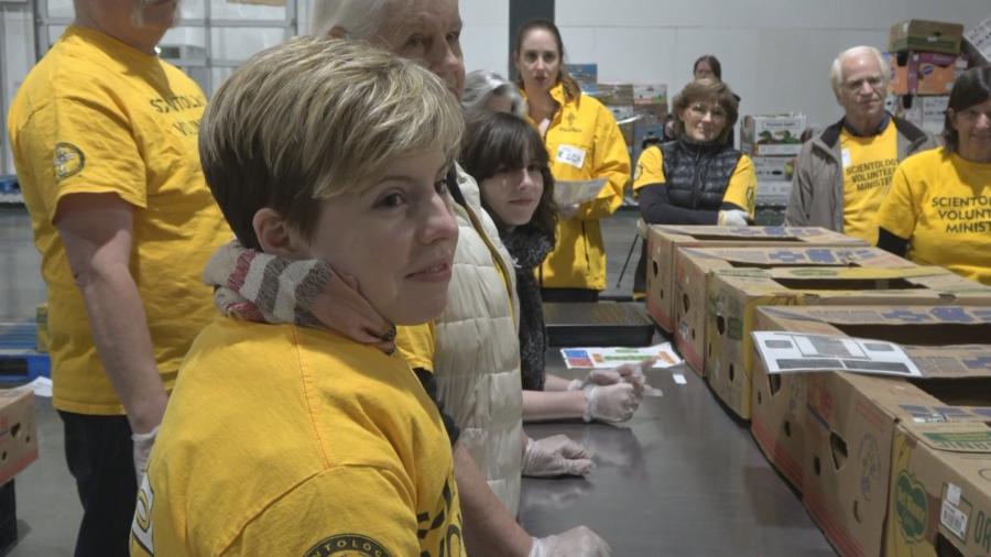 Volunteer Ministers from the Church of Scientology Seattle gather to work at Food Lifeline, packing boxes of food for hungry Seattle families and seniors.