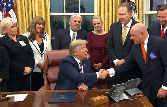President Trump shaking hands with Animal Wellness Action's Executive Director Marty Irby at last night's signing ceremony in the Oval Office