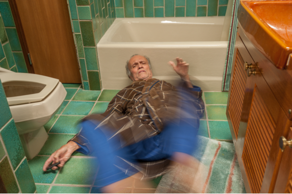 Man on bathroom flor calling for help from is senior home health care aid