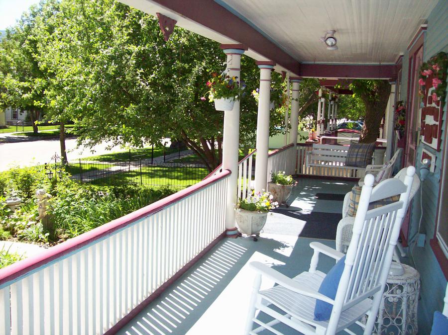 The Victorian verandah offers rocking chairs and old-fashioned porch swings with a view of the garden