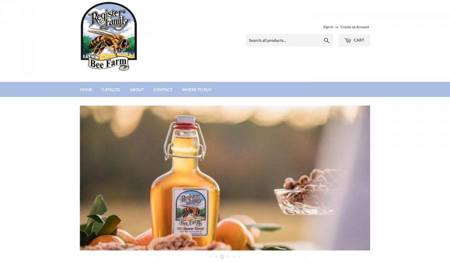 Flip-top bottle of Register Family Farm tupelo honey sitting on a picnic table in the sun