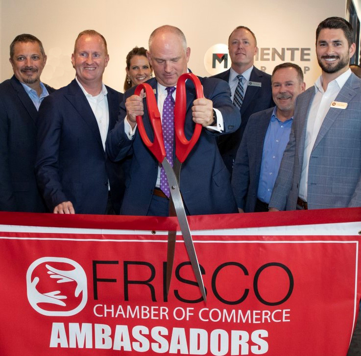 Mente Group President and CEO Brian Proctor (C) cuts the ribbon to the company's new worldwide headquarters in Frisco's prestigious North Dallas' HALL Park.