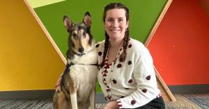 Facility dog Banksy sits with handler Bridgette at Shodair Children's Hospital