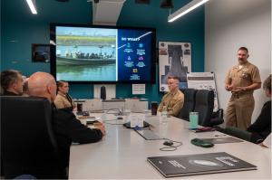 Naval Postgraduate School (NPS) student U.S. Navy Lt. Cmdr. Max Leutermann briefs U.S. Navy Adm. Frank “Mitch” Bradley, commander, U.S. Special Operations Command (USSOCOM), on team's autonomous systems research.