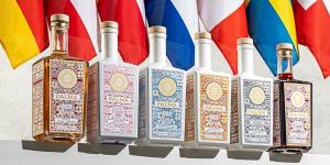 Mallorca Distillerys „Organic Spirit of Palma Gin“ und Palma-Spirituosen vor EU-Flaggen – Symbol für die neue Logistik-Expansion in Deutschland