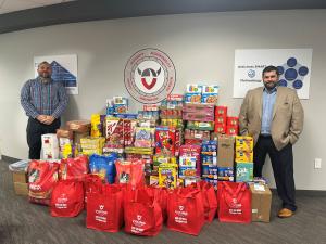 Viking’s President and HR Generalist with the company’s food drive donations, prepared for delivery