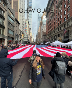 Susan Herson MD smiling in US Navy t-shirt along 5th avenue in New York City as part of Veterans Day Parade 2025