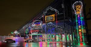 Picture of the entry way at Glittering Lights Las Vegas in 2024 with a giant Santa head and spirit meter in lights,
