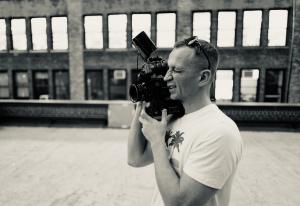 Volodymyr Dorogobid operating a film camera on a New York rooftop