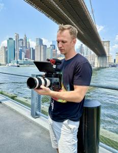 Filmmaker Volodymyr Dorogobid filming near the Brooklyn Bridge in New York