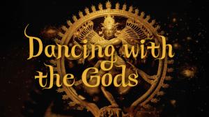 An ornate golden depiction of a multi-armed deity, framed in an intricate circular halo of flames, stands against a dark, glowing background. Over the figure, elegant gold lettering reads “Dancing with the Gods,” creating a mystical and reverent tone that