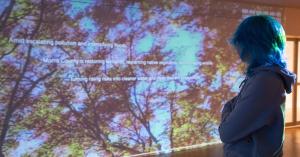 Woman viewing video installation