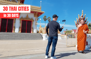 Behind-the-scenes shot of Philip Beere filming a Buddhist monk at a temple for his ‘30 Thai Cities in 30 Days’ travel series.