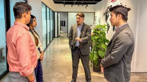 Even Koh presenting to group of international healthcare professionals at Robotimize Malaysia showroom, explaining rehabilitation technology concepts