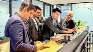 Jackson demonstrating mirror therapy device to international healthcare professionals at Robotimize Malaysia showroom