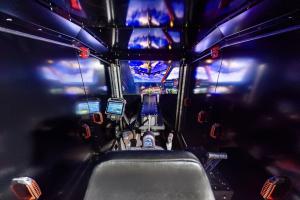 The picture shows the interior of the CymLITE-ATLAS XR Aircrew Trainer and its visual.
