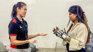 Audrey demonstrating hand rehabilitation device to international healthcare professionals at Robotimize Malaysia showroom