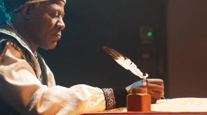 Still image from the documentary We Were Here showing a historical reenactment of a Black Renaissance figure.