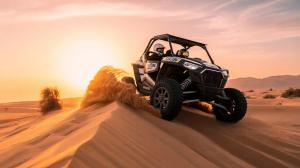 A Dune Buggy Dubai self-drive tour with a Polaris buggy racing over Red desert dunes at sunset, operated by Desert Buggys.