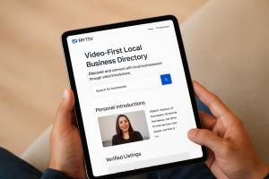 Man with iPad   “Person using an iPad to browse MYTSV.com, viewing video-based listings of local businesses.”