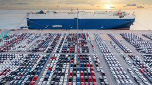 Rows of vehicles awaiting import processing at the Port of Antwerp-Bruges automotive terminal.