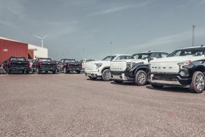 Chevrolet and GMC pickup trucks parked in an import yard before European delivery.