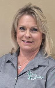 Portrait of Justine Fisher, owner of Sierra Sanitation Inc., smiling while representing the company’s leadership in portable sanitation.