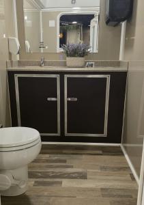 Inside view of a Sierra Sanitation luxury restroom trailer, showing clean, upscale design with high-quality fixtures.