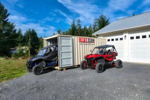Residential storage container rental with an ATV half inside the container and half outside the container