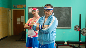 Photo of George and Paul Psarras co-stars of "Tapawingo," streaming on December 2, 2025, across all major TVOD platforms including Apple TV, Prime Video, and Fandango at Home. (L-R: George Psarras as Glenn Gratton and Paul Psarras as Ben Gratton)