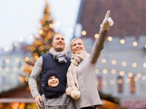 Happy family with child pointing at holiday decorations representing mental wellness support available through Montesano Psychological Center therapy services in Lake County Illinois