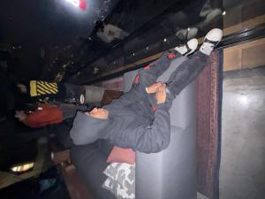 Martyn Kingsley sitting on a couch inside an arena suite, looking toward the event floor.