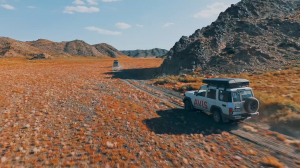 A 4x4 drives through an impressive landscape during a Mongolia tour