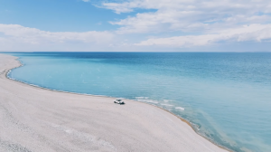 An Explorer.Company 4x4 drives along a beautiful beach during a Mongolia tour