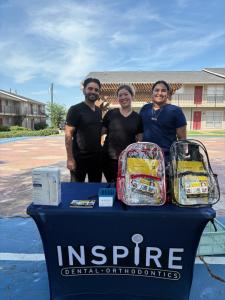 Dr. Darshan Patel and the Inspire Dental team leading an oral health lesson for students during a school event in Garland.