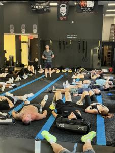 People doing yoga with Greg Bachmann overseeing