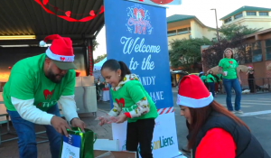 A family enjoying Candy Cane Lane at LATLC's Comfort & Joy, "A Miracle on 34th Street" in Los Angeles