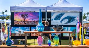 Foreground: vibrant handcrafted art glass; background: colorful landscape photography.