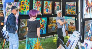 An artist’s booth displaying a curated selection of paintings.