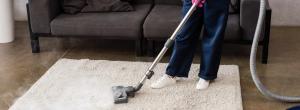 woman cleaning an area rug