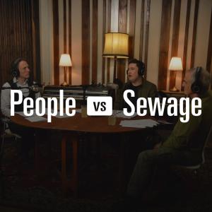 A wide studio shot featuring Philip Greenwood, Paul Powlesland and Ash Smith recording an episode of the People Vs Sewage podcast at Lightship Studios, seated around a round table with microphones, papers and drinks visible.