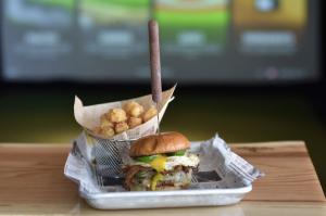 Golf Lounge 18 - Premium burger shown within the indoor golf and entertainment lounge.