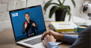 Laptop screen showing Dr. Luis F. Garcia presenting online biomagnetism training during a video call, promoting holiday gift discounts and 0% interest payment plans for Dr. Garcia Biomagnetism courses.