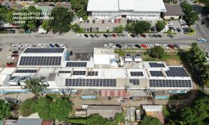 An industrial ice plant building with a Solaren-installed rooftop solar array, showing photovoltaic panels across the facility’s main structure.