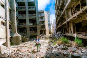 Child walking through building rubble