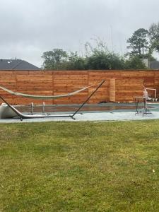 Horizontal cedar privacy fence surrounding a backyard with a hammock and pool area, built by Tony’s Fencing and Iron Works in Southeast Louisiana.