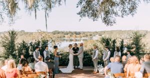 bride and groom saying vows at an outdoor wedding with a lake view at Lakeview Gardens