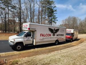 Two Falcon Moving company trucks displaying branding and contact information for Atlanta moving services