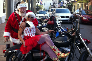 Tom and Gayle O'Connor, Christmas 2018, NOLA, dressed as elf and Santa, on bike