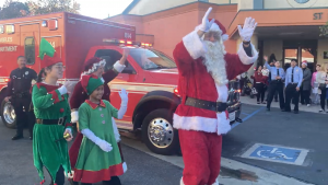 Santa Claus and Mrs. Santa Claus being escorted by their elves and welcoming families to LATLC's 10th Annual Comfort & Joy, "A Miracle on 34th Street" at St. Patrick's Church